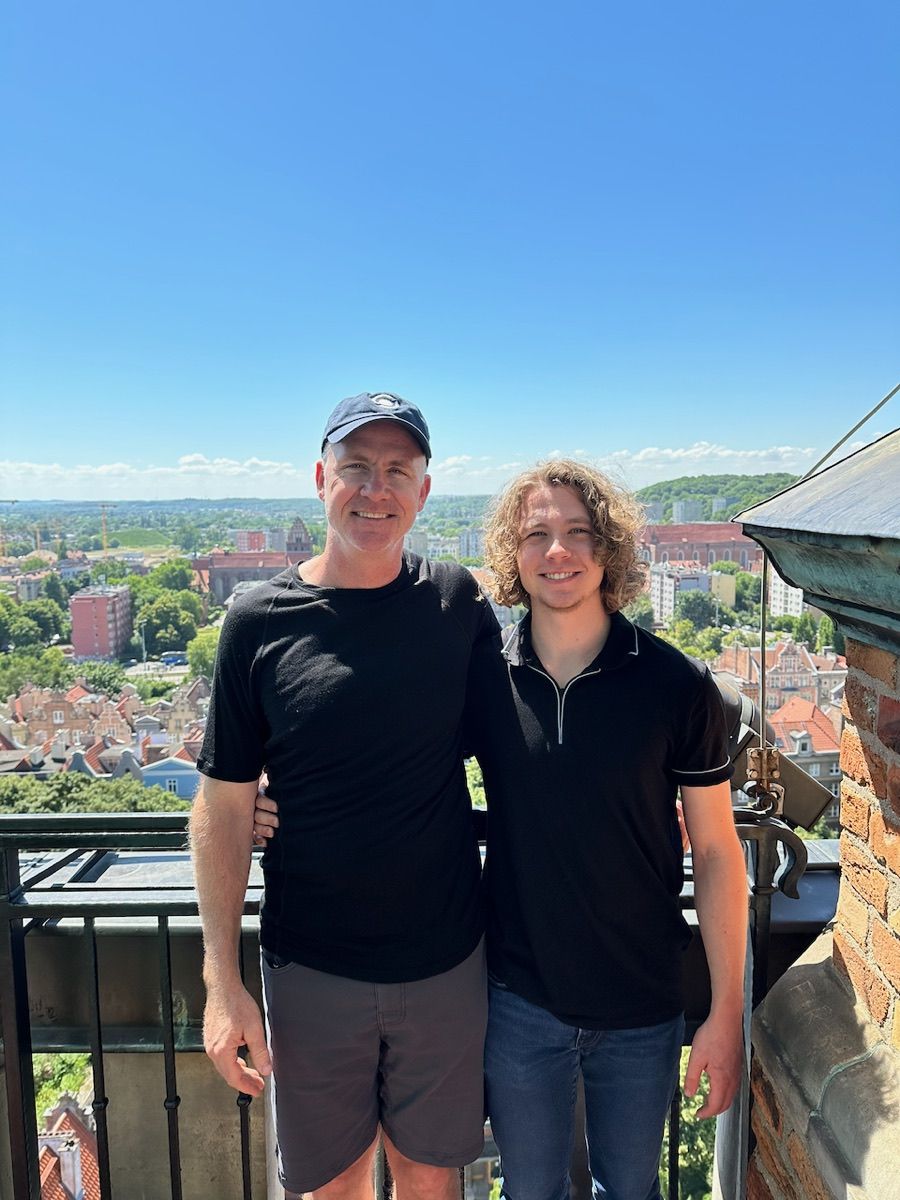 Rolf and Grant Versluis in Prague, arms around each other, on a rooftop in the late afternoon sun
